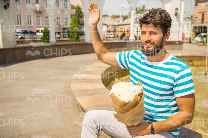 Handsome Bearded Man With Bouquet Waving Hand Stock Photo