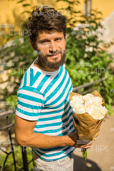 Half-Turned Man With Bouquet Looking At Camera Stock Photo