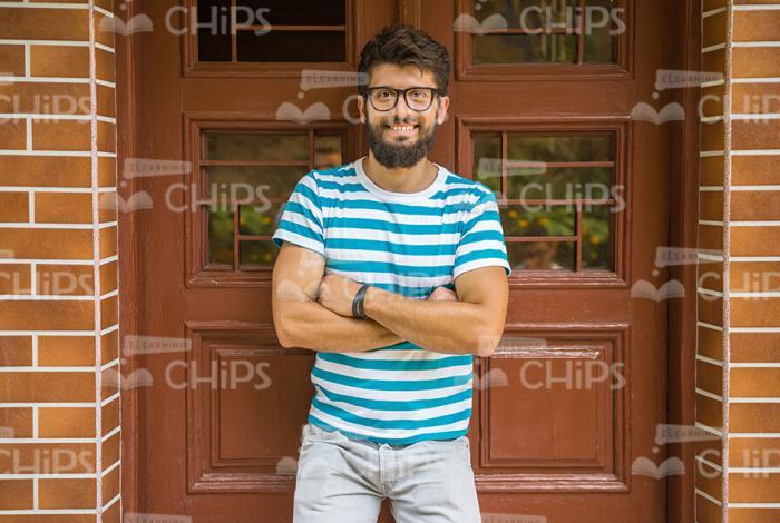 Bearded Young Man Crosses Arms Across The Chest Stock Photo