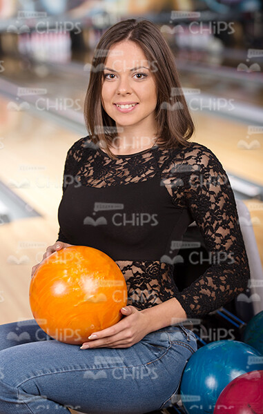 Glad Young Lady Posing With Bowling Ball Stock Photo