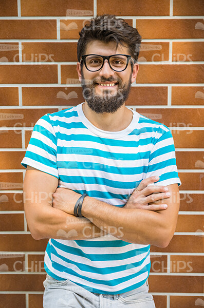 Happy Man In Stripped T-shirt Crosses Arms Stock Photo