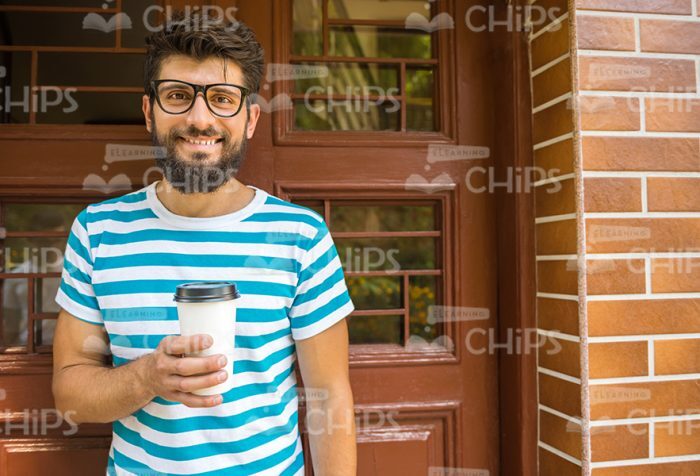 Smiling Bearded Man Holding Coffee Cup Stock Photo