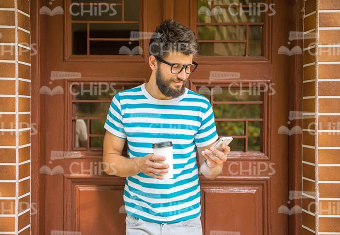 Bearded Man With Mobile Phone And Coffee Cup Stock Photo