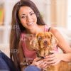 Woman With Dog At Home Stock Photo