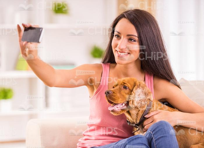 Smiling Woman Taking Selfie With Her Dog Stock Photo