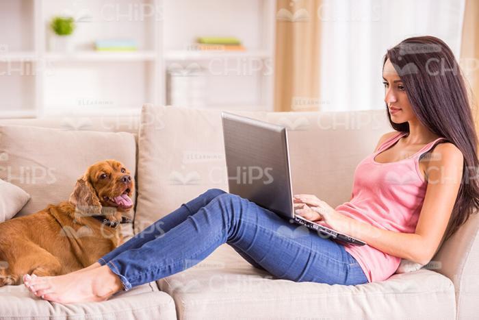 Woman With Her Pet On The Sofa Stock Photo
