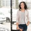 Pretty Young Woman At Dealer Shop Stock Photo