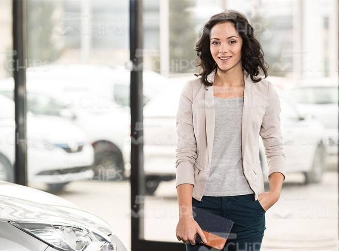 Pretty Young Woman At Dealer Shop Stock Photo