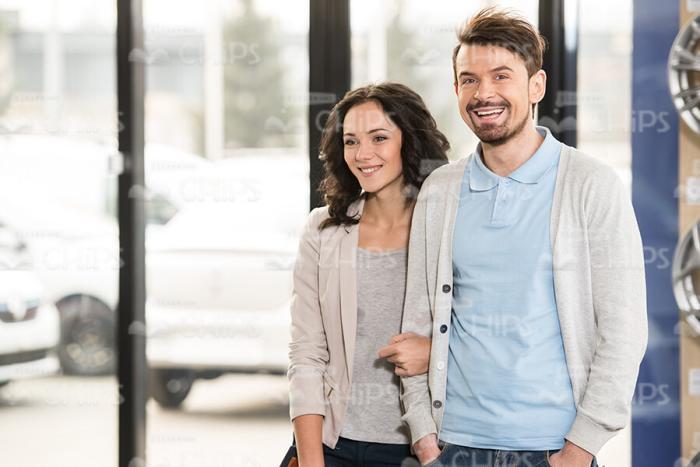 Nice Young Couple Visiting Car Showroom Stock Photo