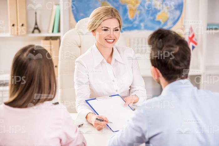 Female Manager Showing Contract To Clients Stock Photo