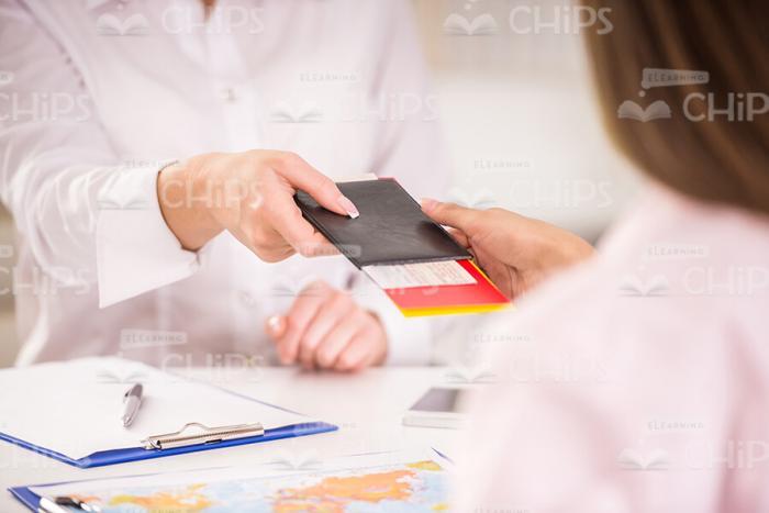 Manager's Hand Giving Tickets To Client Stock Photo