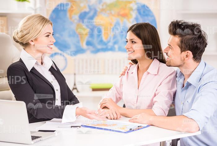 Travel Agency Manager Talking With Clients Stock Photo