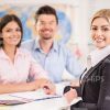 Pretty Businesswoman With Clients Stock Photo