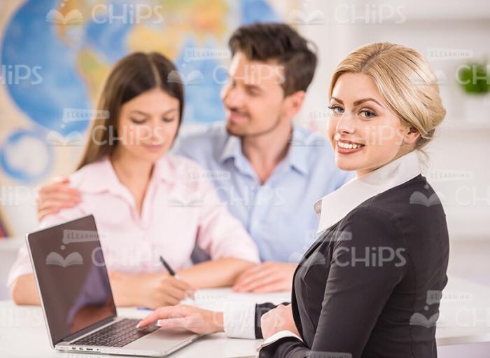 Young Travel Agency Manager Turns To Camera Stock Photo