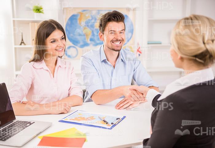 Smiling Couple At Travel Agency Stock Photo
