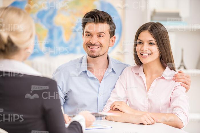 Happy Couple Going To Buy The Vacation Tour Stock Photo