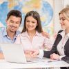 Young Couple With Travel Agent Booking The Hotel Stock Photo