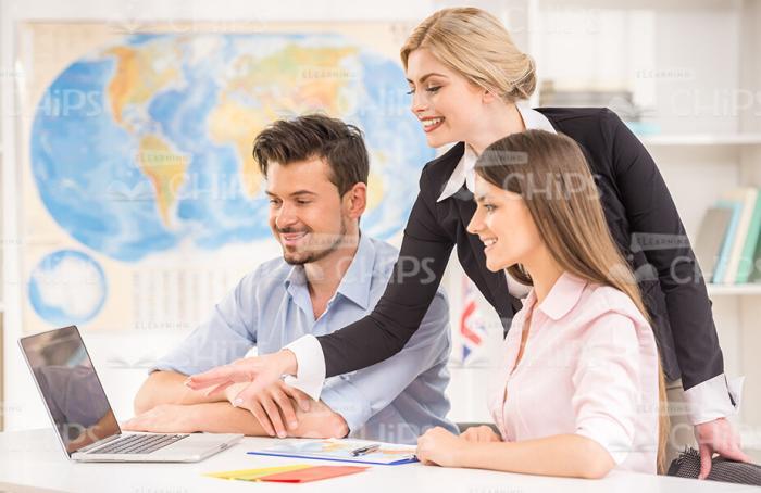 Happy Clients At The Travel Agency Choosing The Vacation Stock Photo