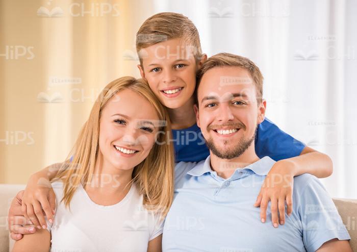 Smiling Son Hugging His Parents Stock Photo