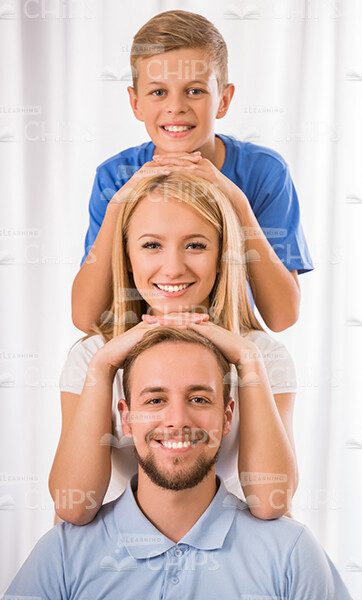 Smiling Young Family Making Pyramid Gesture Stock Photo