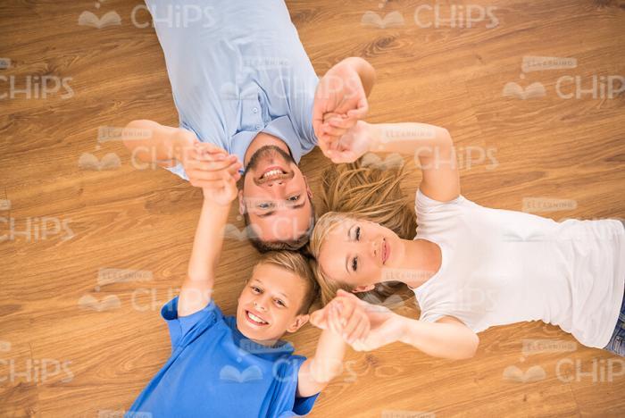 Happy Family Lying On Floor Stock Photo