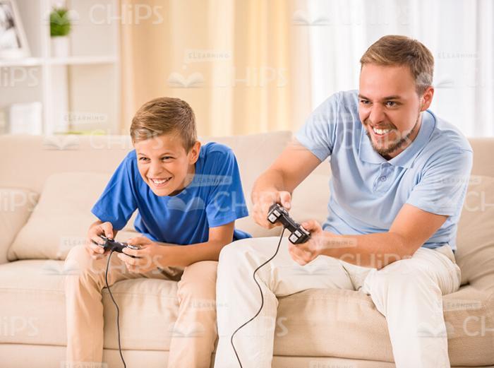 Father And Son Playing The Video Game Stock Photo