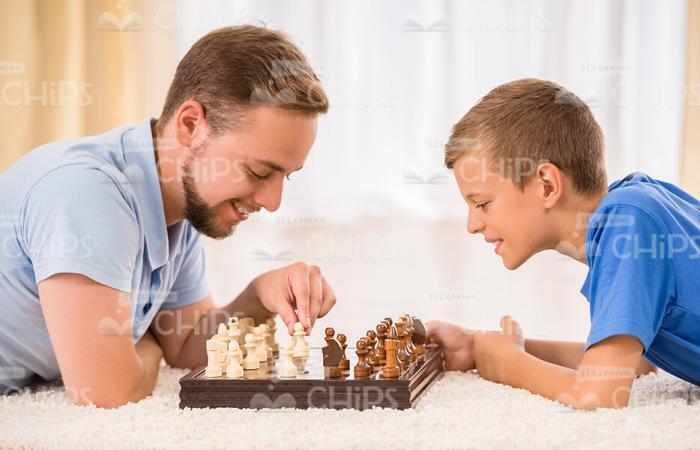 Family Playing Chess Stock Photo