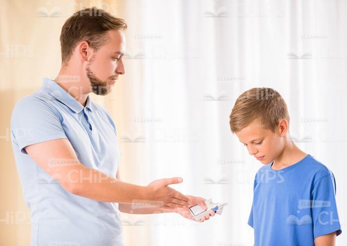 Father Scolds His Son For Cigarettes Stock Photo
