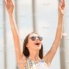Smiling Woman Raising Up Both Hands Stock Photo