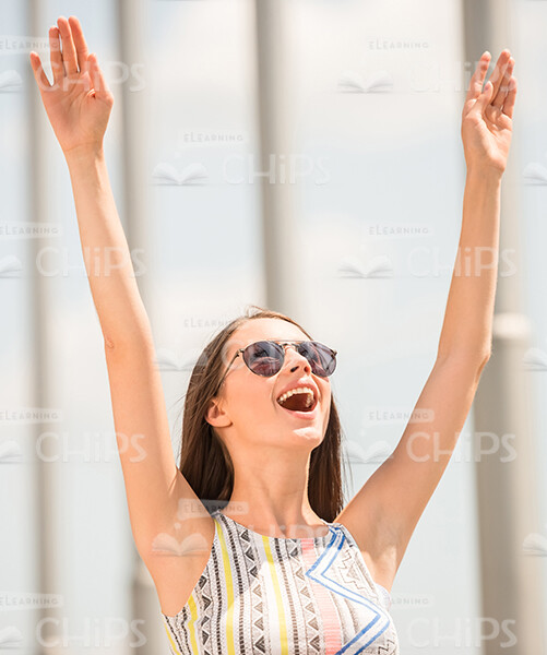 Smiling Woman Raising Up Both Hands Stock Photo