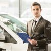 Sales Manager At Car Showroom Stock Photo