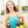 Nice Young Girl With Roller Skates Smiles At Camera Stock Photo