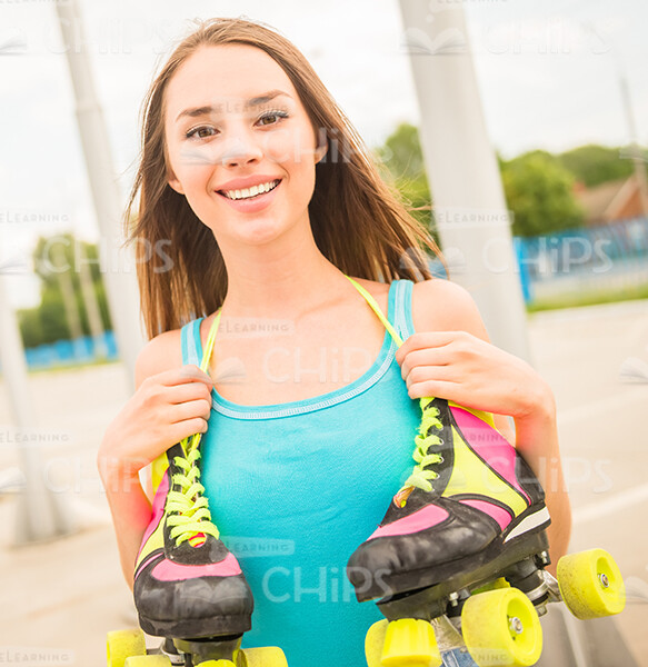 Nice Young Girl With Roller Skates Smiles At Camera Stock Photo