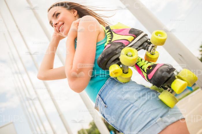 Young Girl Holding Roller Skates Stock Photo