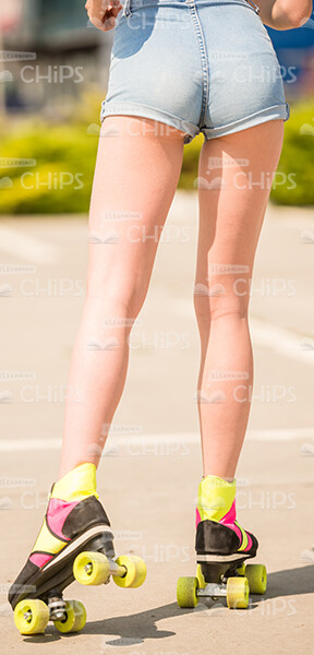Back View Of Girl's Legs With Rollers Stock Photo