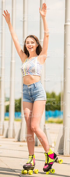 Handsome Girl Roller Skating And Raising Hands Up Stock Photo