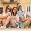 Two Young Girls And Handsome Man Resting Stock Photo
