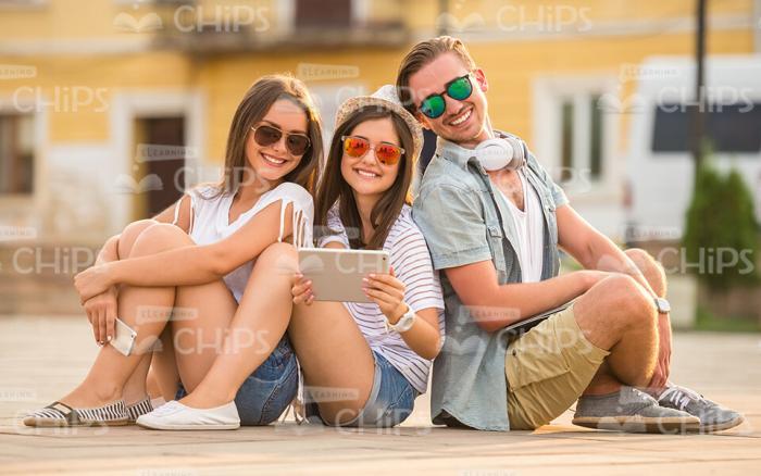 Two Young Girls And Handsome Man Resting Stock Photo