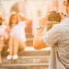 Man Holding Camera And Taking Picture Of His Friends Stock Photo