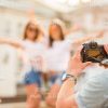 Young Man Photographing Girls Stock Photo