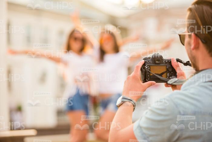 Young Man Photographing Girls Stock Photo