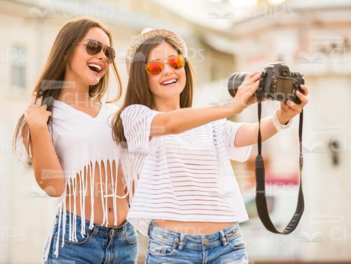 Cute Girls Having Fun While Taking Photos Stock Photo