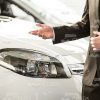 Salesman Presenting New Car Stock Photo