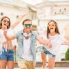 Happy Young Man Showing His Thumbs Up While Having Fun With Girls Stock Photo