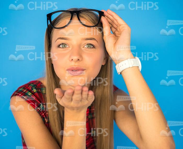 Flirty Female Model Blows Kiss Stock Photo