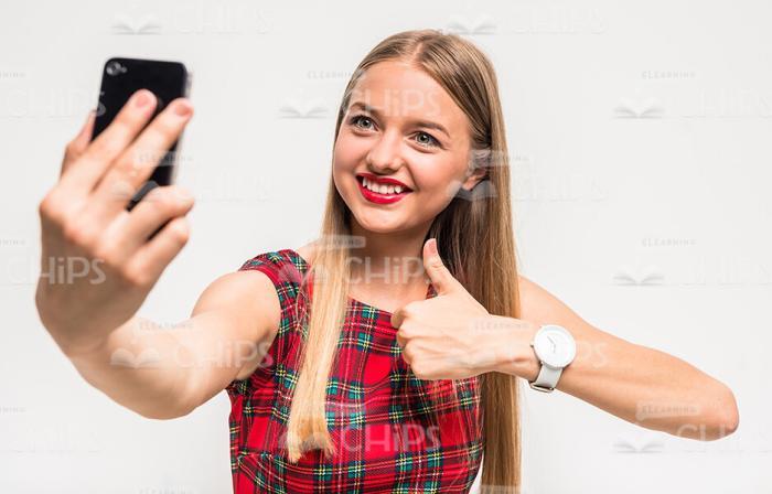 Cute Young Girl Taking Selfie And Showing Thumbs Up Stock Photo
