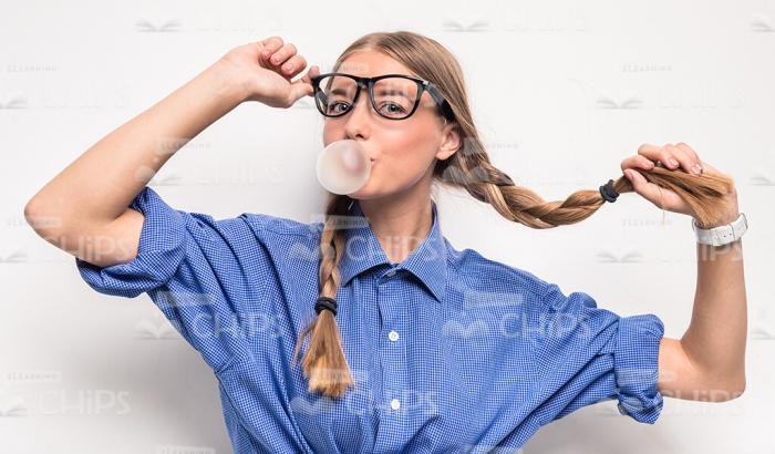 Pretty Model With Bubble Gum Holding Her Hair Braid Stock Photo