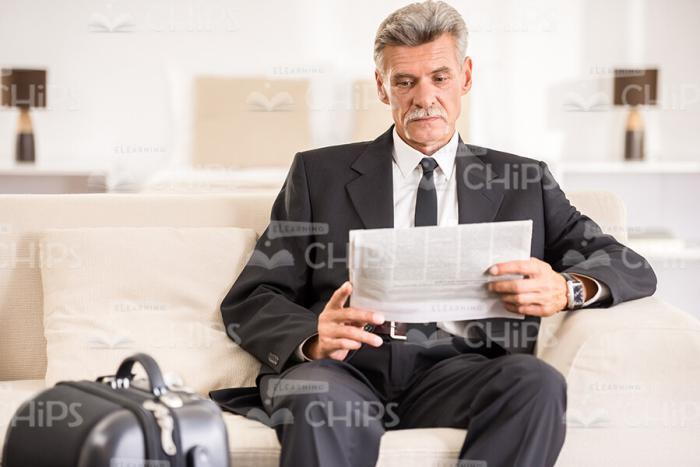 Focused Businessman Reading Newspaper Stock Photo