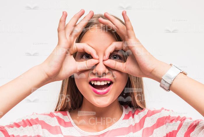 Girl Showing Glasses With Her Hands Stock Photo