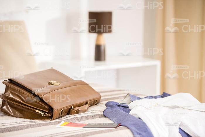 Men's Clothes And Briefcase On Bed Stock Photo